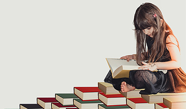 Ragazzina Che Legge Seduta Sui Libri